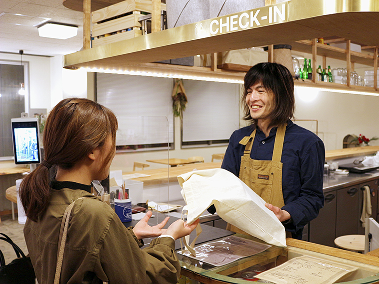 オーナーの伊藤さんが笑顔で出迎えてくれる。宿泊の方にはアメニティー、部屋の管理ができるタブレット端末、ウニコインを渡される