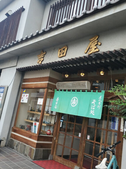 風格を感じる金文字の看板と鮮やかなのれん
